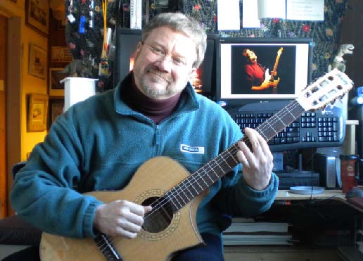 Scotty West playing nylon string classical guitar in his teaching studio.
